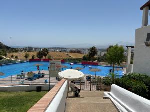 a person holding an umbrella in front of a swimming pool at Apartement cabo in Tétouan