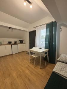 a living room with a table and a kitchen at Przystanek Zator in Zator +41 photos