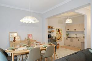 a dining room and kitchen with a table and chairs at Freya Apartments - Spacious 85 m2 2 Bedroom Private Home in Xanthi