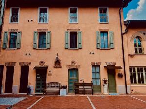 a large orange building with doors and windows at La Casina in Dello