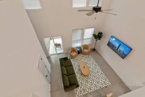 an overhead view of a living room with a couch and a tv at Lagniappe House Cajun Country Gem King Bed in Lafayette