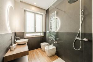 a bathroom with a sink and a toilet and a shower at 6 Isonzo - Luxury Stay Verona in Verona +44 photos