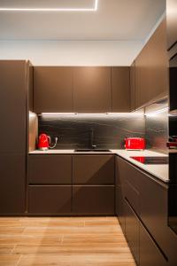 a kitchen with brown cabinets and red appliances at 6 Isonzo - Luxury Stay Verona in Verona