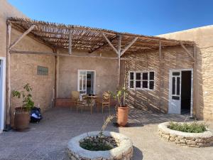 a patio with two large planters in front of a building at Adam house in Essaouira