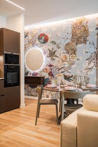 a dining room with a table and a wall mural at 6 Isonzo - Luxury Stay Verona in Verona