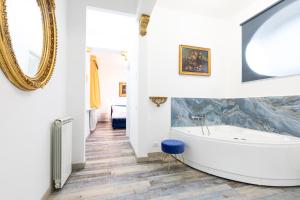 a bathroom with a tub and a mirror at Il Monastero Collection in Rome +61 photos