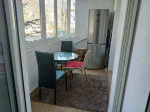 a kitchen with a table and chairs and a refrigerator at Casa del Mar in Eforie Nord