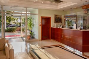 a lobby with a reception desk in a building at Hotel Dobrovit in Baška
