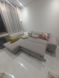 a living room with a couch with pillows on it at malaga mansouria cosy moderne studio 1 ch salon canape lit moderne in Mansouria
