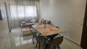 a living room with a table and a couch at malaga mansouria cosy moderne studio 1 ch salon canape lit moderne in Mansouria