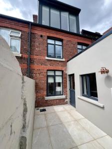 an empty courtyard in front of a brick building at IFSC Townhouse Apartments in Dublin