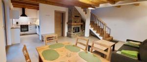 a kitchen and a living room with a table and chairs at Pienińskie Kąty in Krościenko