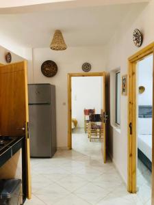 a kitchen with a refrigerator and a dining room at AFRICA SURF HOUSE in Taghazout