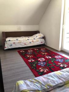 a bedroom with two beds and a rug on the floor at Villa Malesia in Peje
