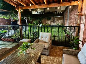 Un patio con mesa y sillas y una valla. en Lindo dpto con vista al jardin, internet y cable, en Lima