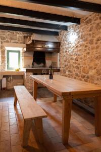 a wooden table with two benches in a room at Villa Maria in Pašman +11 photos