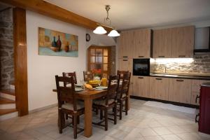 a kitchen with a wooden table and chairs in a room at Villa Maria in Pašman
