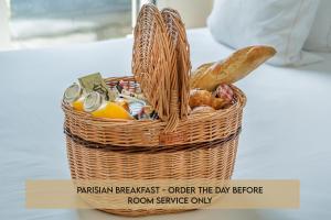 a basket of food sitting on top of a table at Yuna Porte-Maillot - ApartHotel in Paris