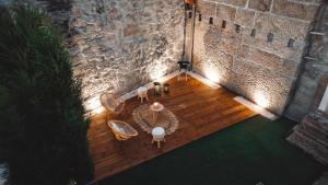 Draufsicht auf einen Tisch und Stühle auf einer Holzterrasse in der Unterkunft Paducho Studios in Valpaços
