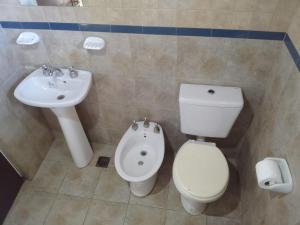 a bathroom with a sink and a toilet and a bidet at Casa Blanca in San Carlos de Bariloche +16 photos