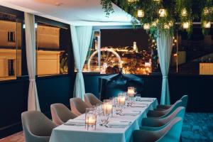 a long table in a room with chairs and a window at Five Seas by Inwood Hotels in Cannes