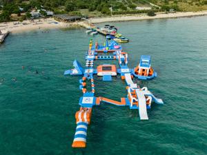 an inflatable water park in the water near a beach at Terra Park Phalaris in Novalja