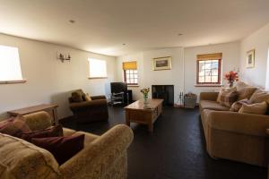 a living room with couches and a coffee table at Balvraid Steading - Awesome views, near Dornoch in Dornoch