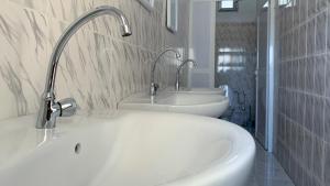 a white bathroom with a sink and a tub at Les HOTELS TALHAYA, NOUAKCHOTT in Nouakchott +65 photos