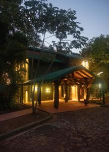 a building with a green awning at night at Iguazu Jungle Lodge in Puerto Iguazú