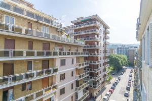 an apartment building with cars parked on a street at Lingotto District Functional Apartment in Turin