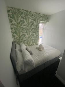a bedroom with a bed with two stuffed animals on it at Marine Cottage 2 - With Private Hot Tub in Newbiggin-by-the-Sea
