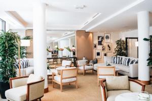 a lobby with couches and chairs and plants at Five Seas by Inwood Hotels in Cannes