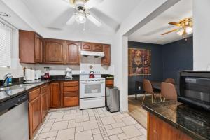 a kitchen with wooden cabinets and a stove top oven at Country Happiness in Richardson