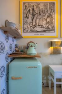 a refrigerator in a kitchen with a picture on the wall at Unieke Bed en Breakfast met historisch verhaal in Ferwert De K roon van Marijn in Ferwerd