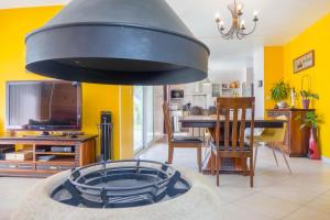 a living room with a fireplace and a dining room at Maison familiale à la campagne in Donnery