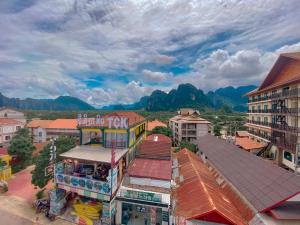 an overhead view of a city with buildings and mountains at Vang Vieng Golden Dragon House in Vang Vieng