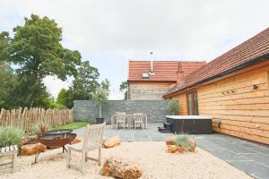 a patio with a grill and a table and chairs at Cedar lodge - Hopewell in Bristol