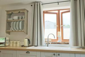 a kitchen with a sink and a window at Cedar lodge - Hopewell in Bristol +29 photos