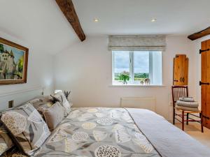a bedroom with a large bed and a window at 4 Bed in Masham 64329 in Grewelthorpe