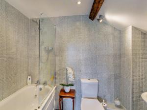 a bathroom with a shower and a toilet and a tub at 4 Bed in Masham 64329 in Grewelthorpe +28 photos
