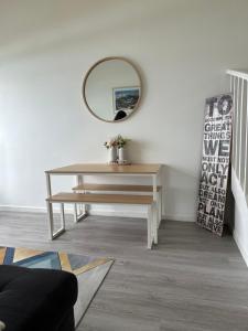 a dressing table with a mirror on a wall at 9 Whitecrest Great Ocean Road Resort - Ocean View in Apollo Bay +2 photos