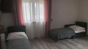 a small room with two beds and a window at Apartment Ferienhaus in Würzburg