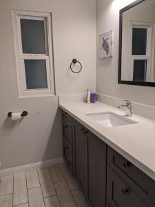 a bathroom with a sink and a mirror at 124 Thirty Fourth Street B in Newport Beach +11 photos