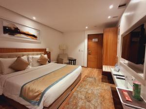a hotel room with a bed and a television at Best Western Plus Tejvivaan in Visakhapatnam