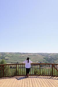 a woman standing on a deck looking at the hills at Casa d'Albarróis in Alenquer