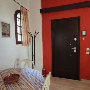 a dining room with a table and a black door at Cozy City Apartment - sleeps 2 in Rhodes Town