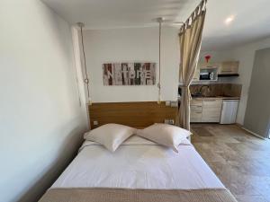 a large bed in a room with a kitchen at HomeStay Bormes in Bormes-les-Mimosas +38 photos