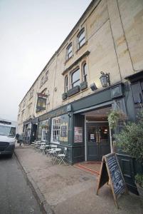 a store with a sign in front of a building at The Alma Taverns Boutique Suites - Room 1 - Hopewell in Bristol