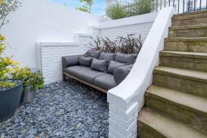 a couch sitting on the side of a brick wall at Host & Stay - Osbourne Rest in Brighton & Hove