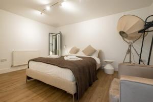 a bedroom with a large bed and a fan on the wall at Host & Stay - Osbourne Rest in Brighton & Hove +27 photos